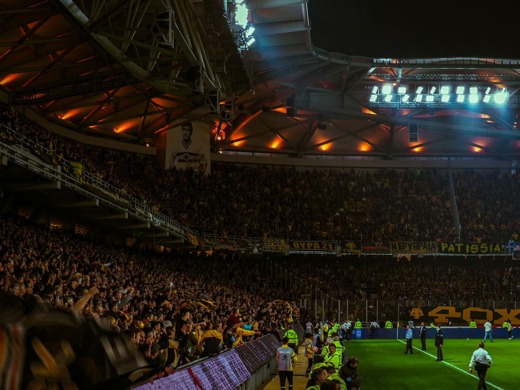Exciting night soccer game with packed cheering fans and vibrant stadium lights.