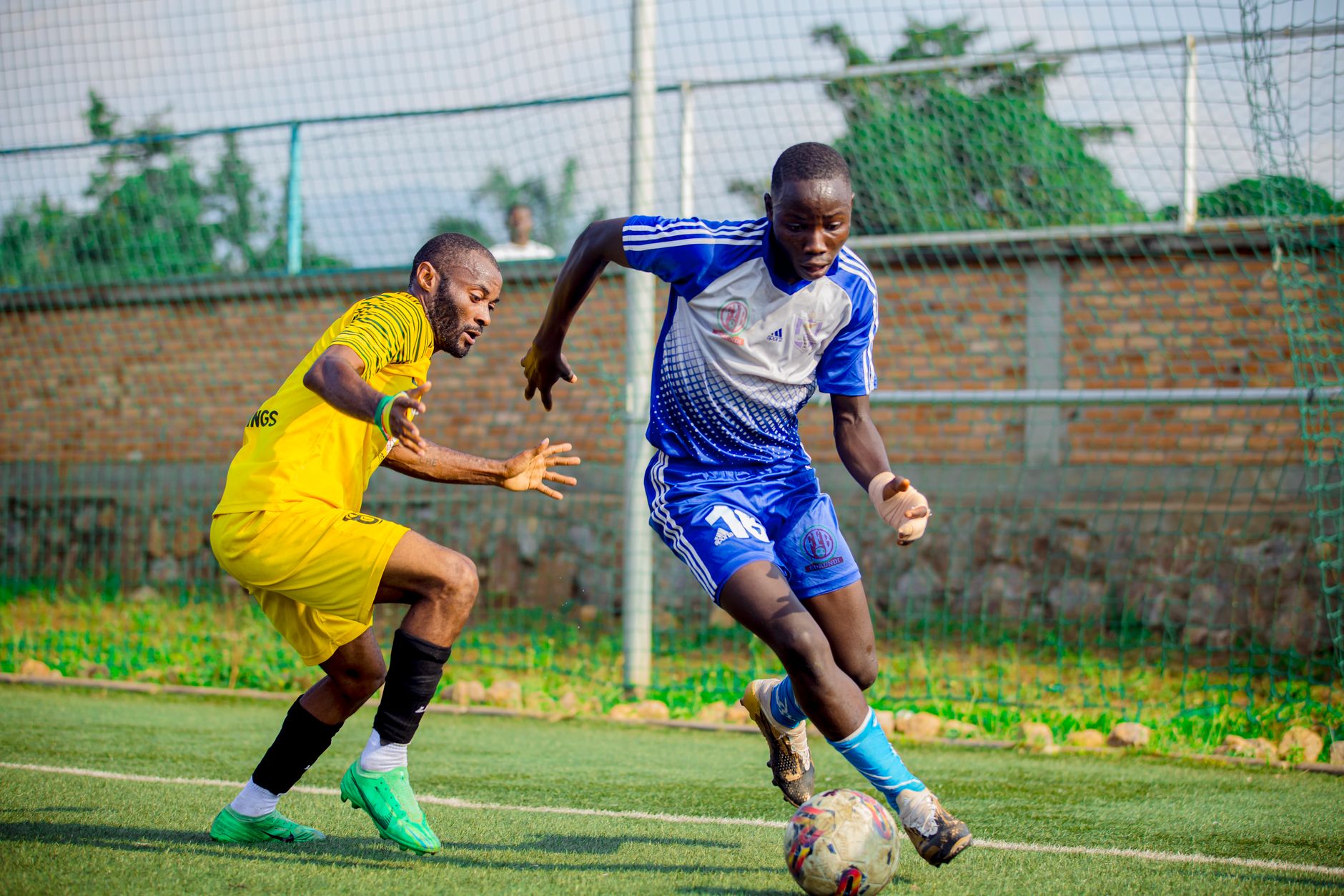 Two male soccer players engage in an intense match on an outdoor field.
