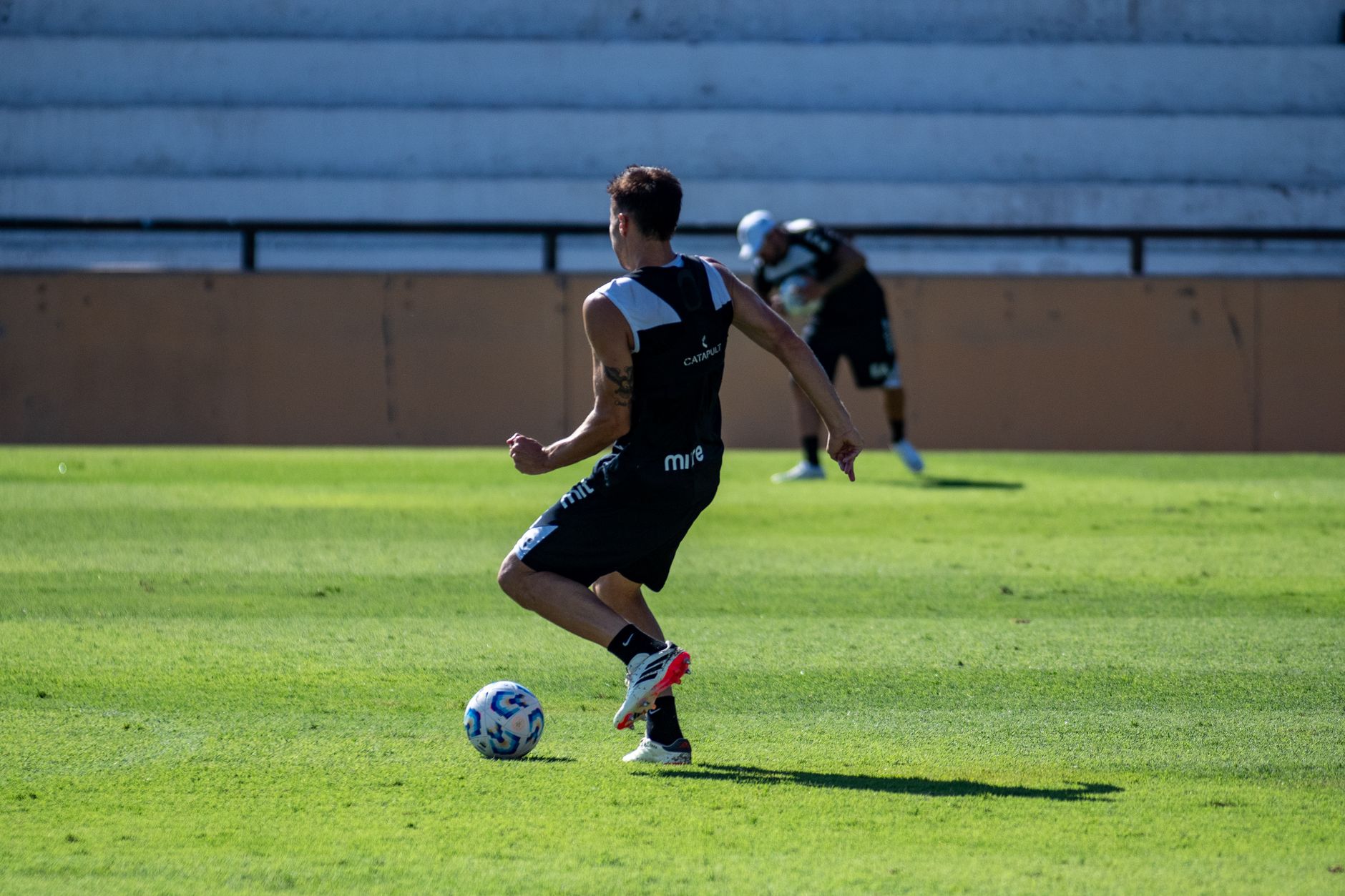 A soccer player training on a sunny day, showcasing agility and skill.
