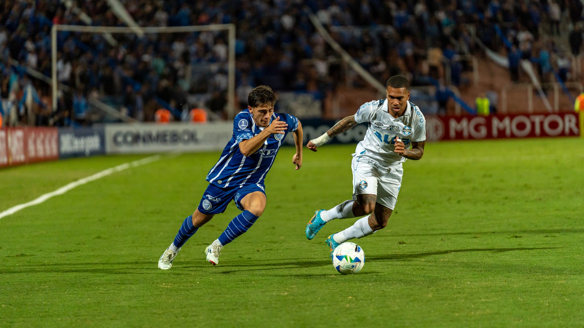 Intense soccer match showcasing players vying for control of the ball on a vibrant, well-lit field.