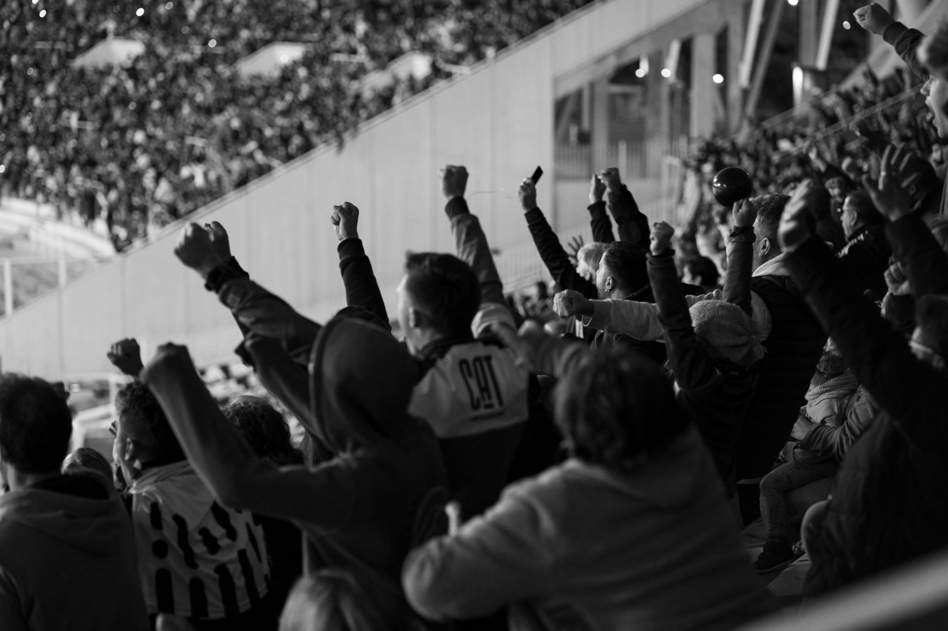 Vibrant crowd of football fans cheering in a Córdoba stadium, Argentina.