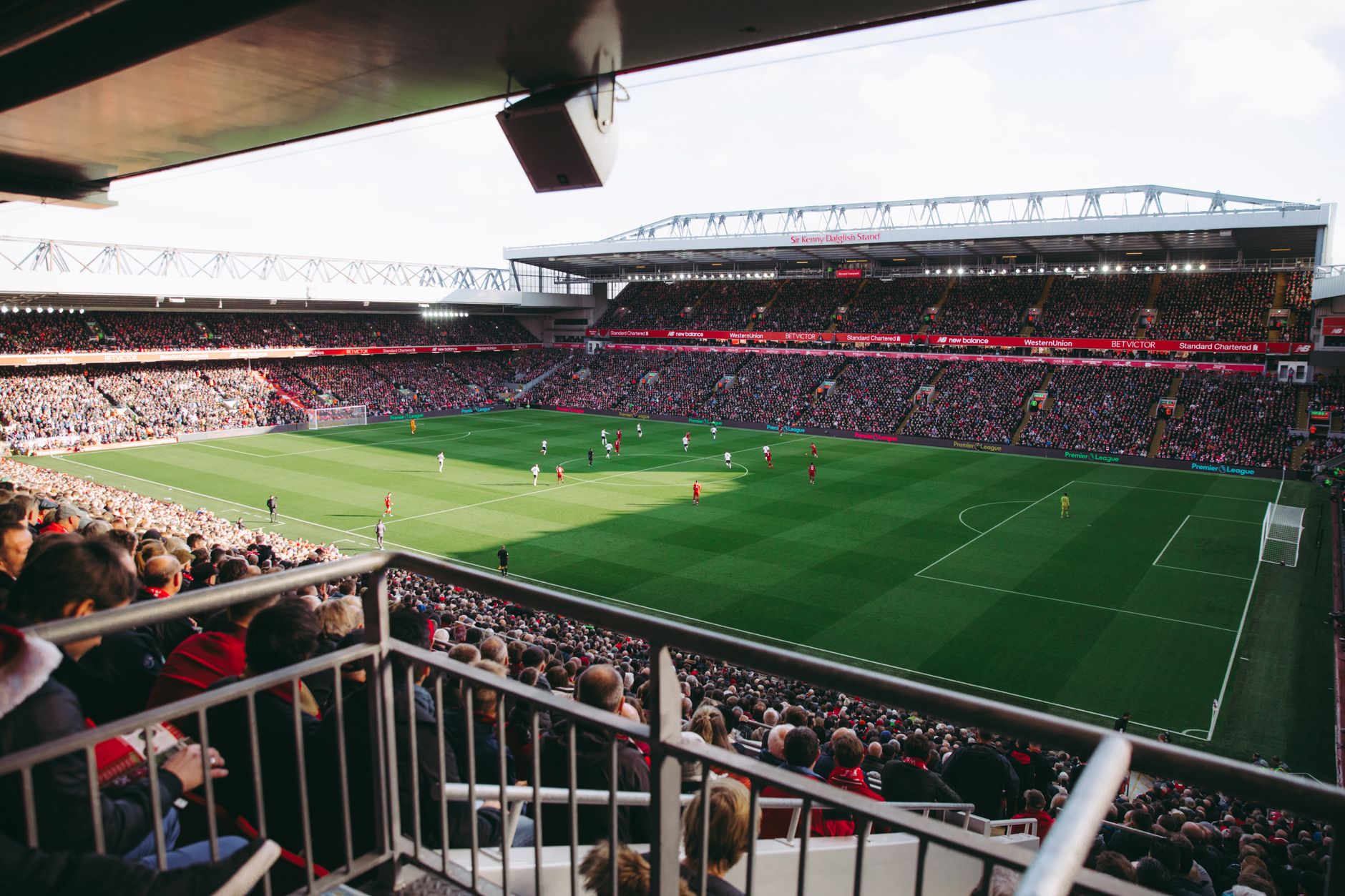 A vibrant soccer game with a full crowd in a modern stadium, capturing the energy of the sport.