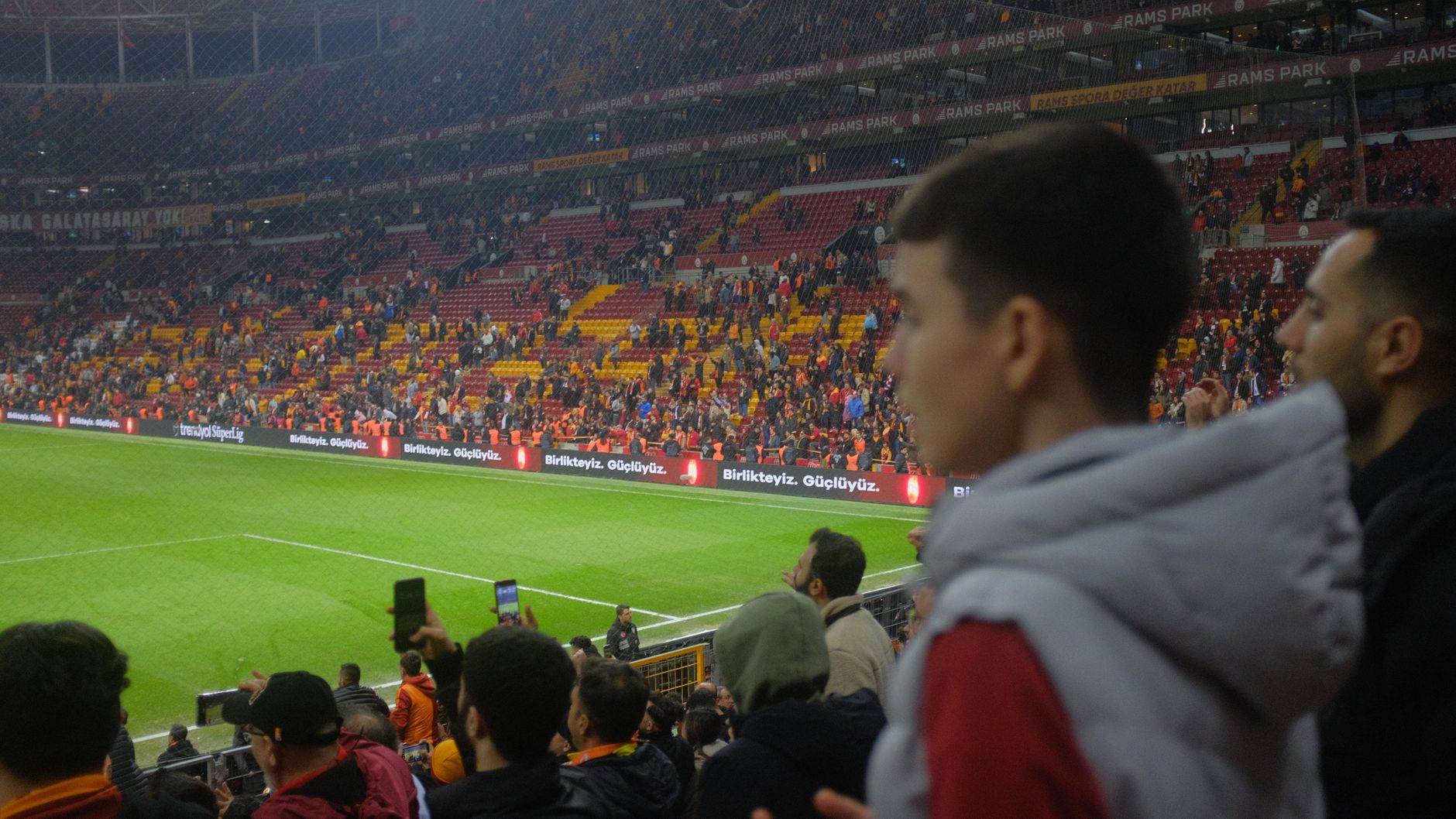 Crowd at a thrilling soccer match in Istanbul stadium with vibrant atmosphere.