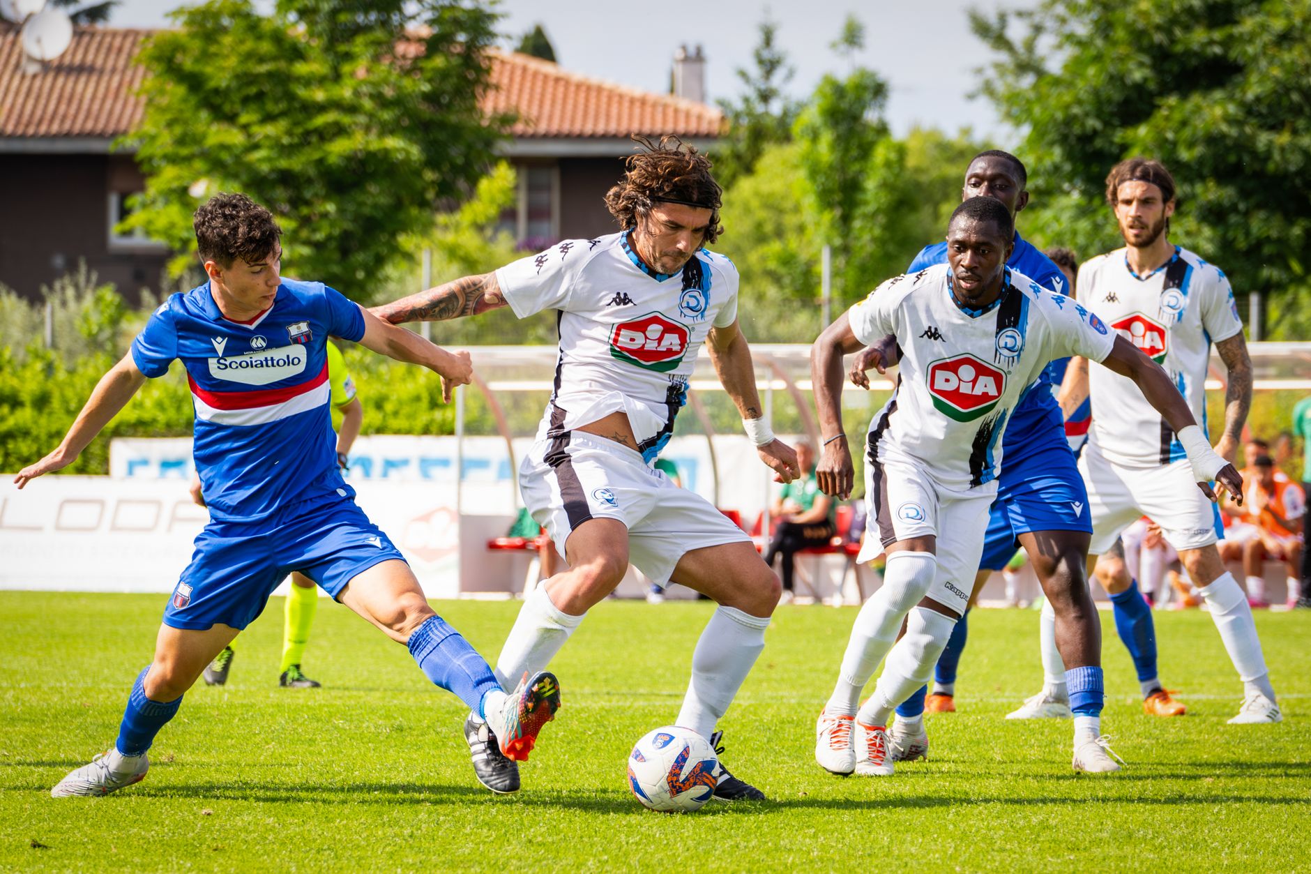 Exciting soccer match with players in action on a sunny field. Intense competition and athleticism displayed.