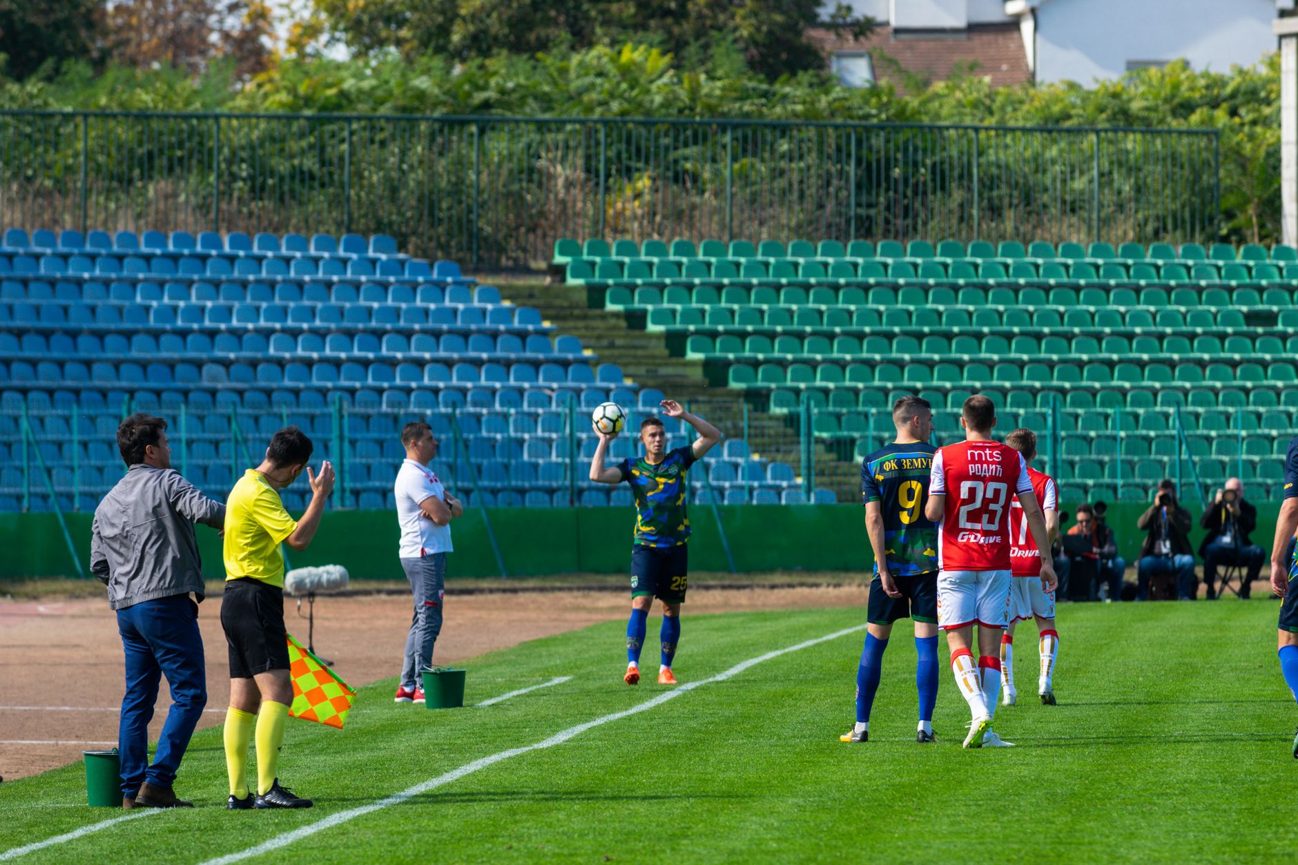 Soccer players in action during a lively match at an outdoor stadium.