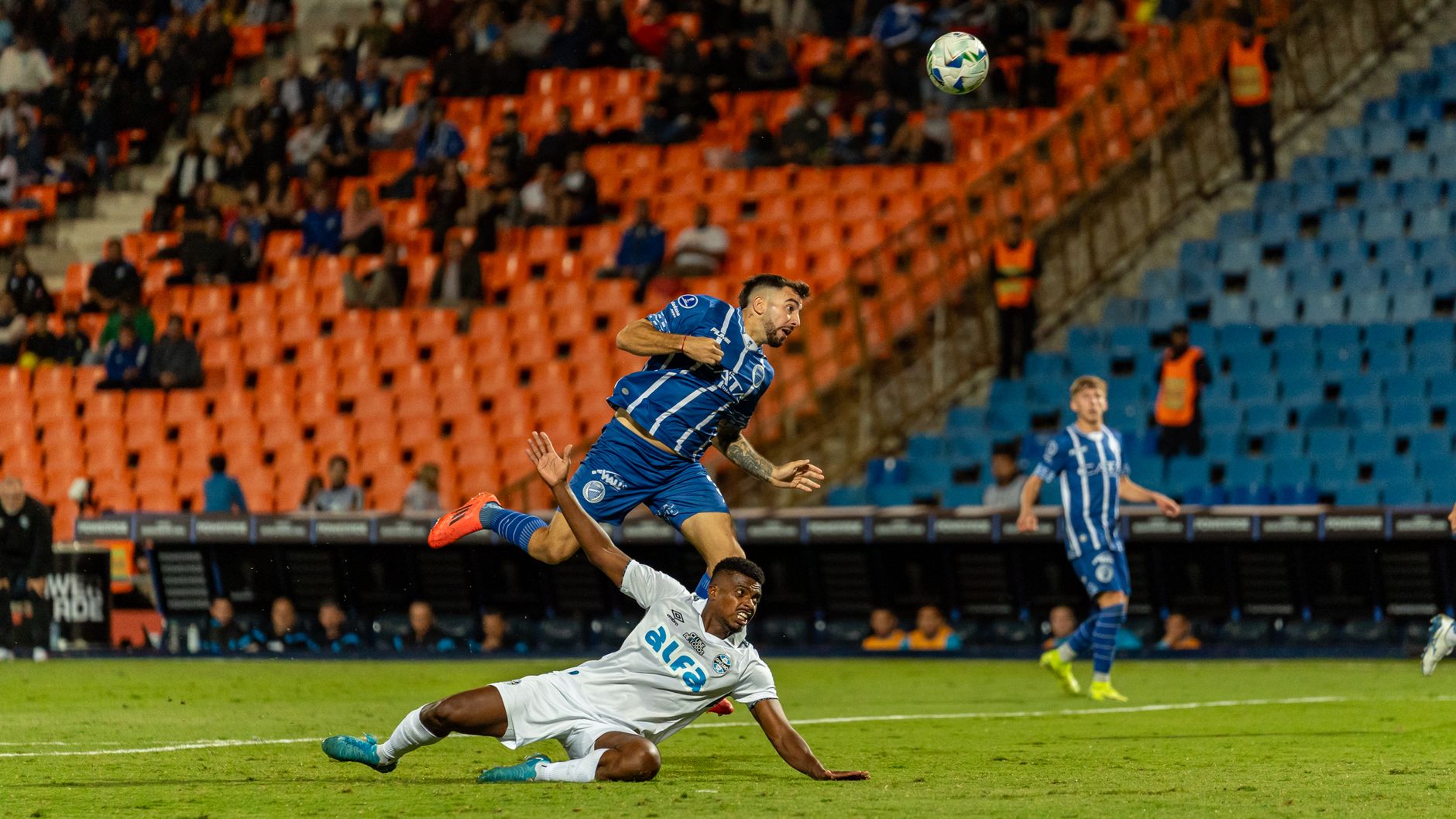 Exciting soccer match action with players in motion, capturing intense athleticism on the field.