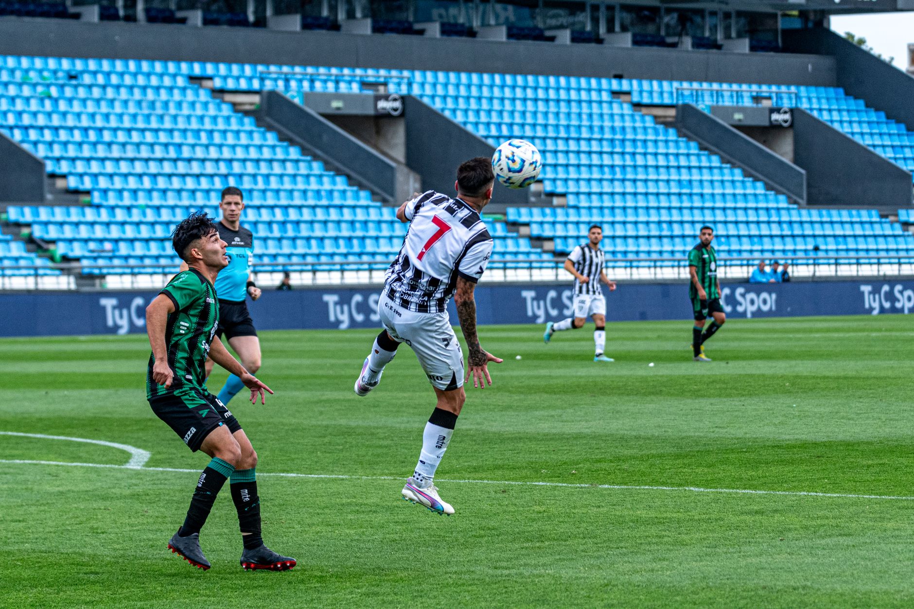 Action-packed soccer match with players competing in a vibrant stadium.