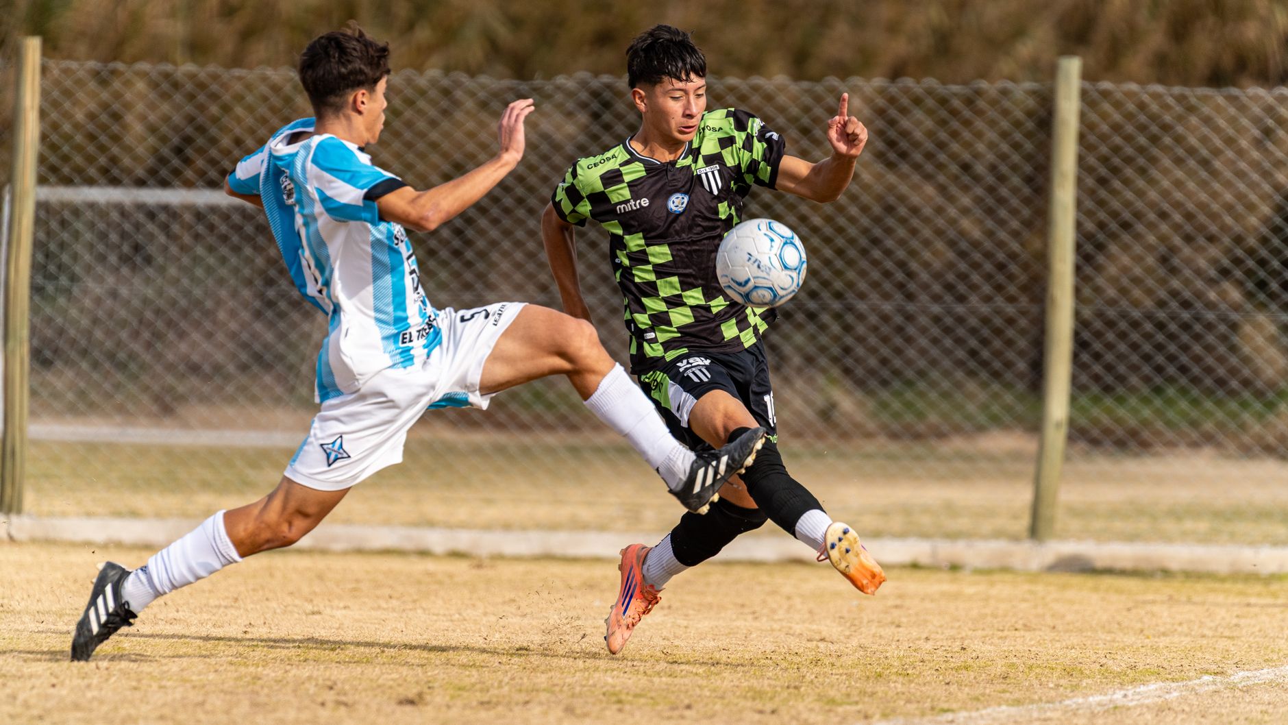 Two soccer players in action during a competitive outdoor match.