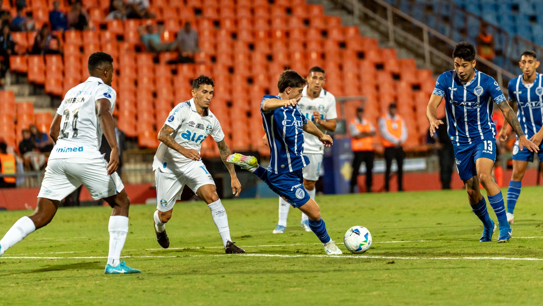 Dynamic action shot of a soccer match highlighting players in motion on the field during a competitive game.