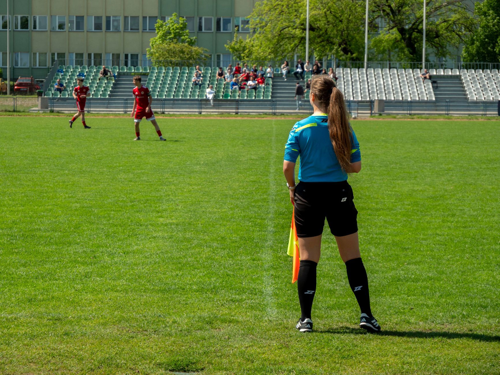 Female football referee oversees a match at a stadium in Wrocław, Poland.
