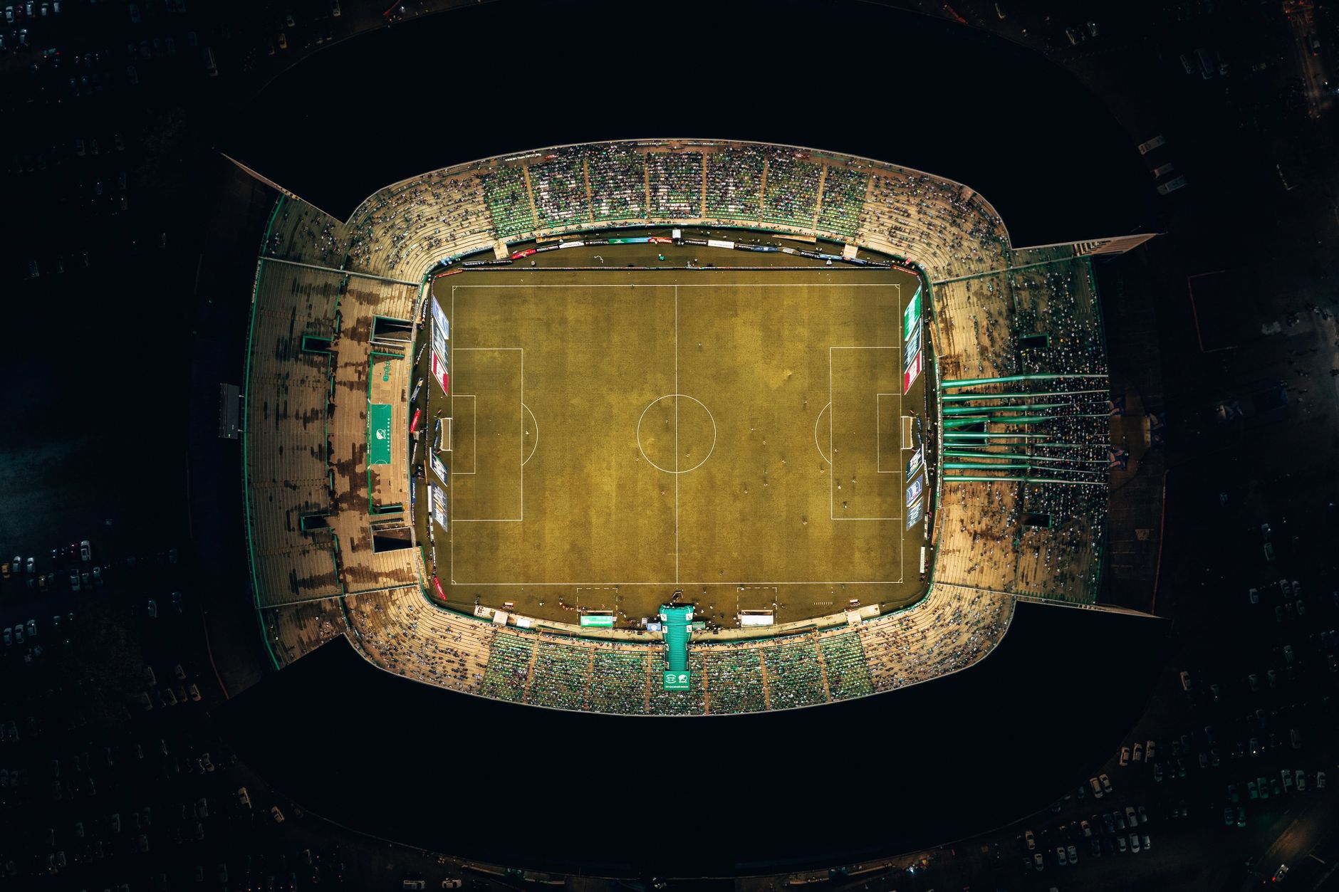 Overhead view of a well-lit soccer stadium at night in Palmira, Colombia.